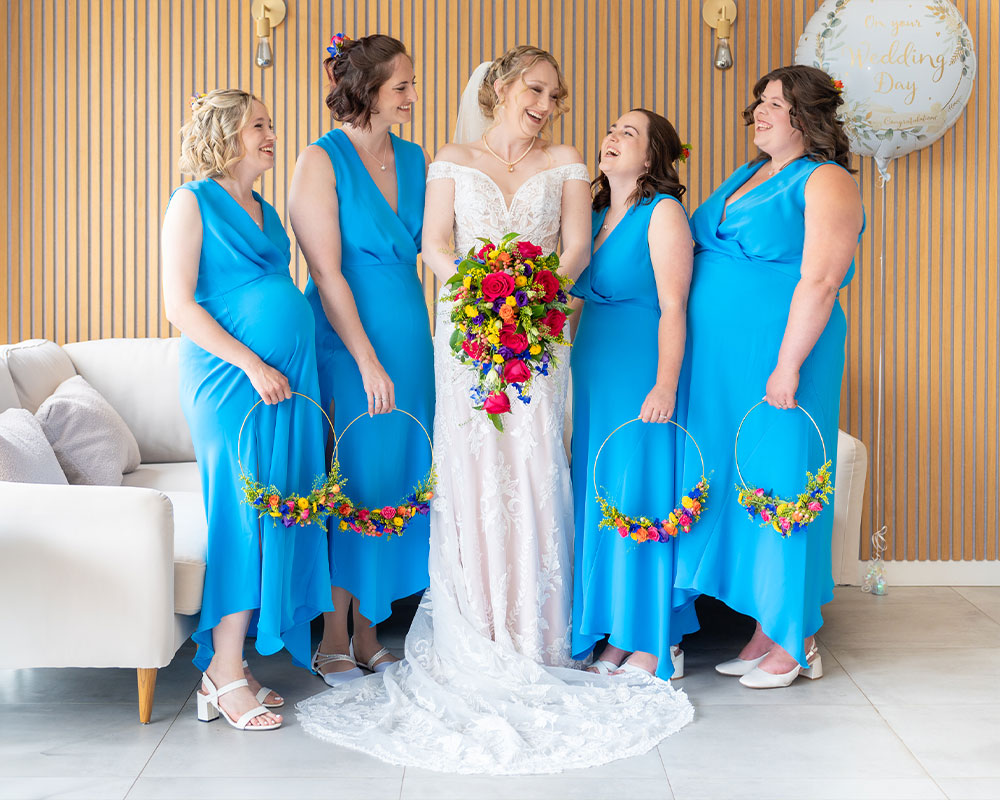 Bride and Bridemaids laughing Upton Barn and Walled Garden