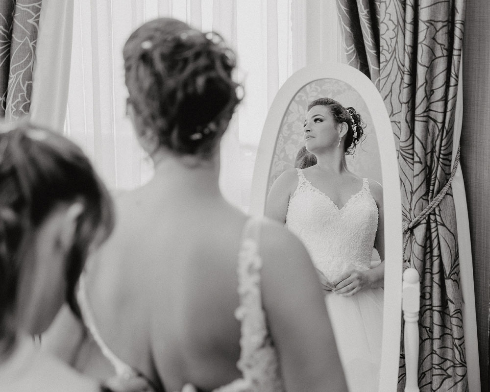 Bride in the mirror, black and white bridal prep photo.