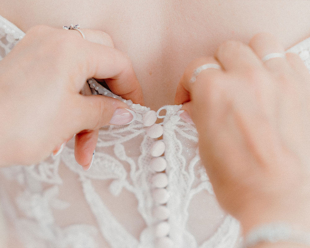 Back of Wedding dress, being fastened.