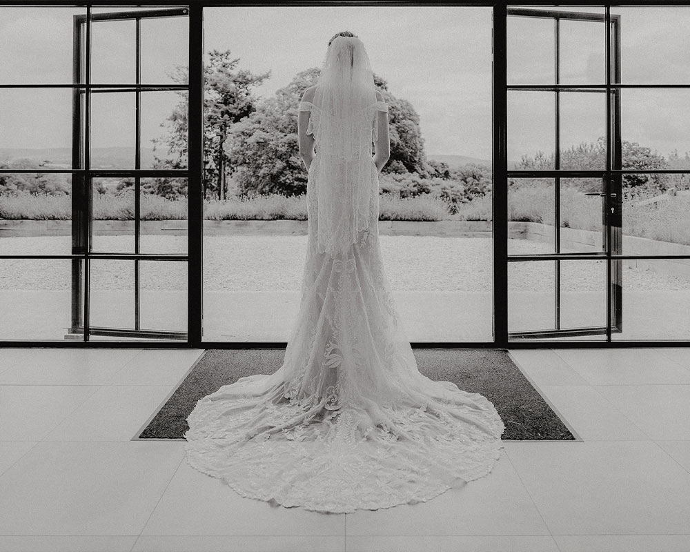 Bride looking out across the Upton Barn and Walled Garden